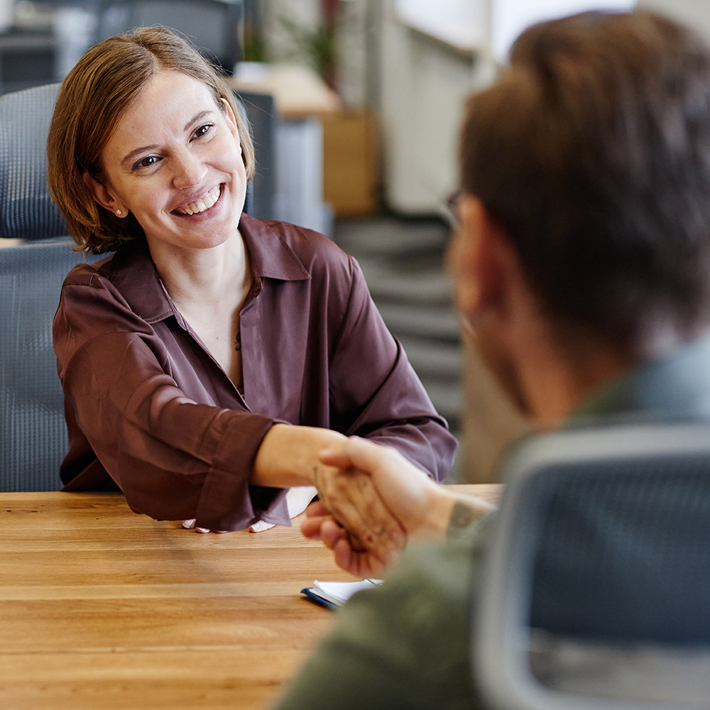 woman shaking hands in a business setting