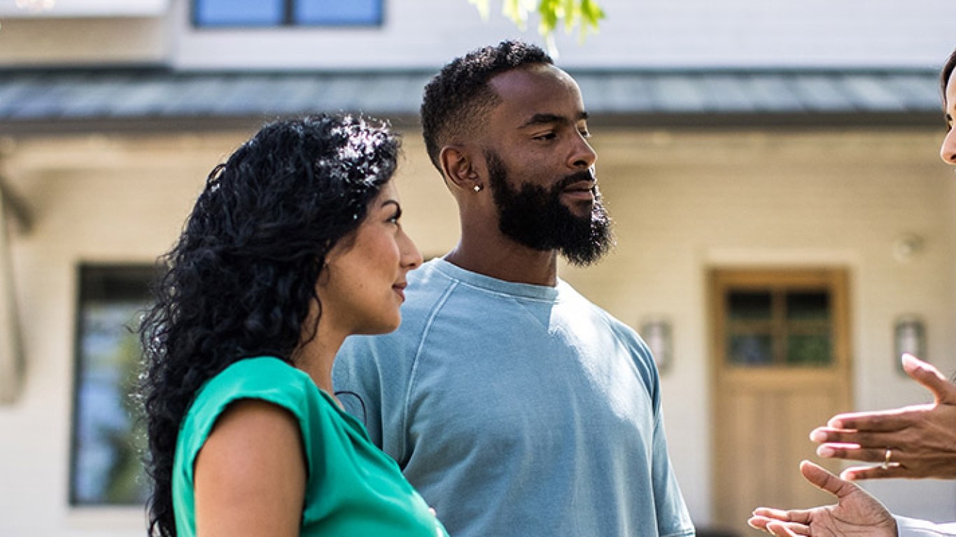 Real estate professional helping couple look for homes