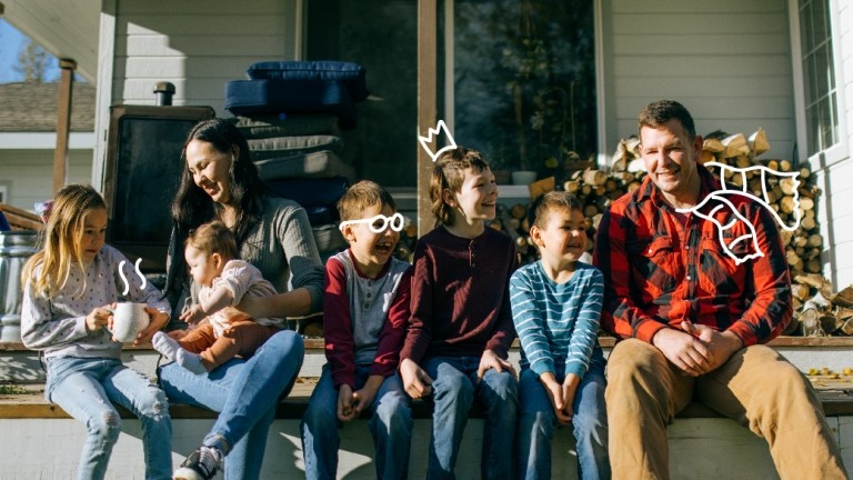 Family sits on the steps of their home