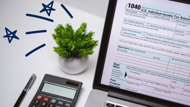 Computer screen with 1040 form and plant on desk