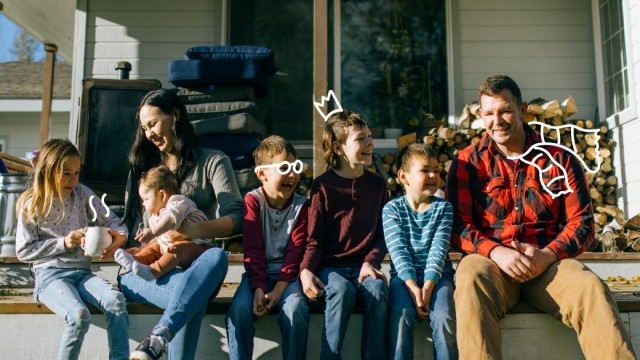 Family sits on the steps of their home