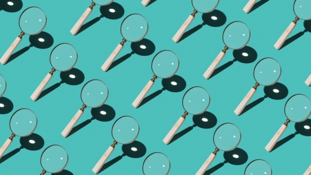 Magnify glasses arranged in a diagonal pattern over a blue background.