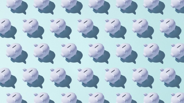 Porcelain white piggy banks in rows with shadows on light blue background.