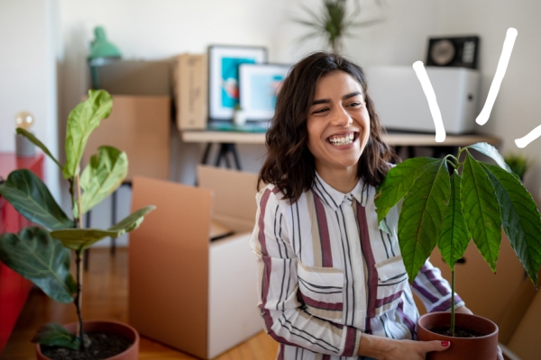 Excited woman in her new house with moving boxes. 
