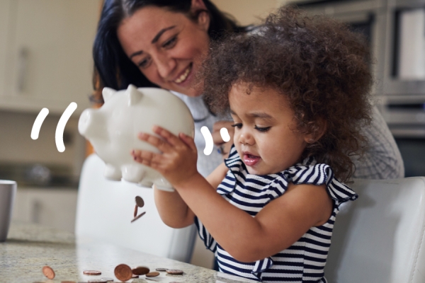 Child holds a piggy bank with squiggles in the air. 
