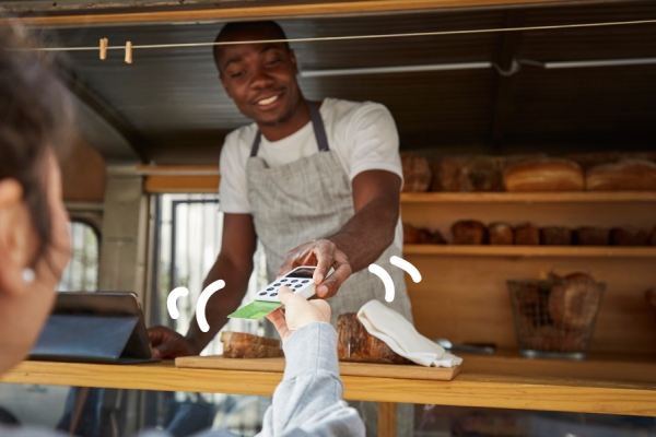 Man asks for payment in his shop. 