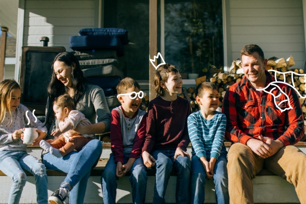 Family sits on the steps of their home