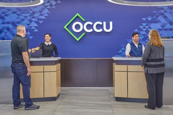 Bank tellers assisting members in an OCCU credit union branch.
