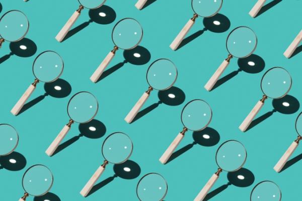Magnify glasses arranged in a diagonal pattern over a blue background.